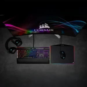 Top-down view of a full Corsair gaming setup including K95 keyboard, mouse, headset, and monitor.