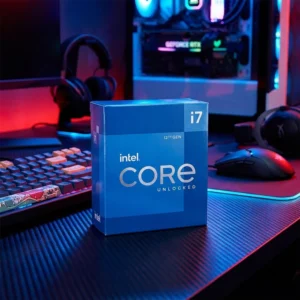 Intel Core i7-12700KF retail box on a carbon fiber texture desk in a blue-lit room.
