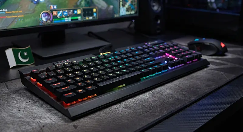 Best mechanical keyboard setup in Pakistan featuring a Corsair K70 RGB on a gaming desk with a Pakistani flag.
