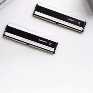 Top-down flat lay view of two white G.SKILL Trident Z5 RGB DDR5 memory sticks.