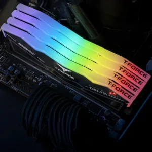 Multiple TeamGroup Delta RGB DDR5 modules installed on a motherboard displaying a rainbow gradient lighting effect.