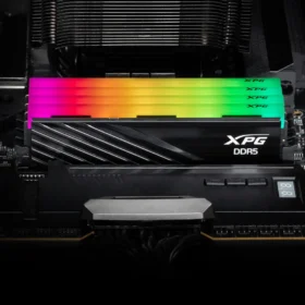 Four XPG Lancer Blade RGB DDR5 RAM sticks installed on a motherboard with rainbow lighting effects