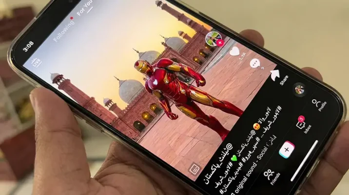 A smartphone screen displaying the TikTok app interface with Urdu text, showing Pakistani creators posting trending AI videos featuring Disney characters in local cities like Lahore.